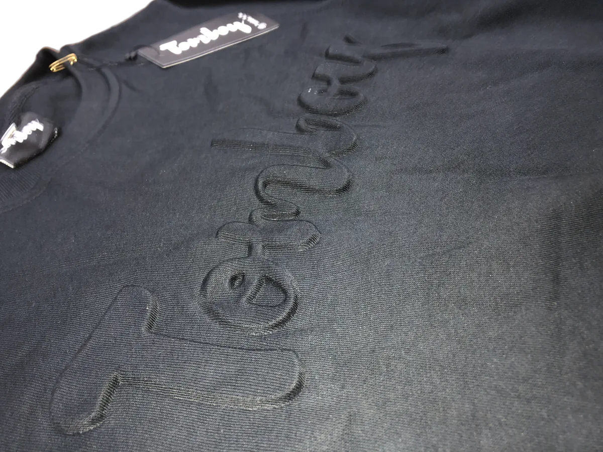 Tomboy — tone-on-tone embossed detail
